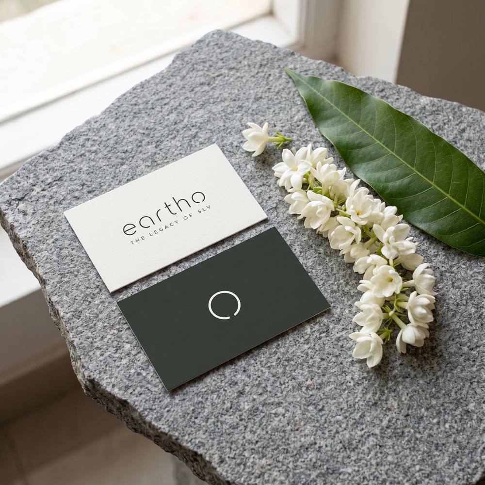 Eartho business cards on granite with jasmine